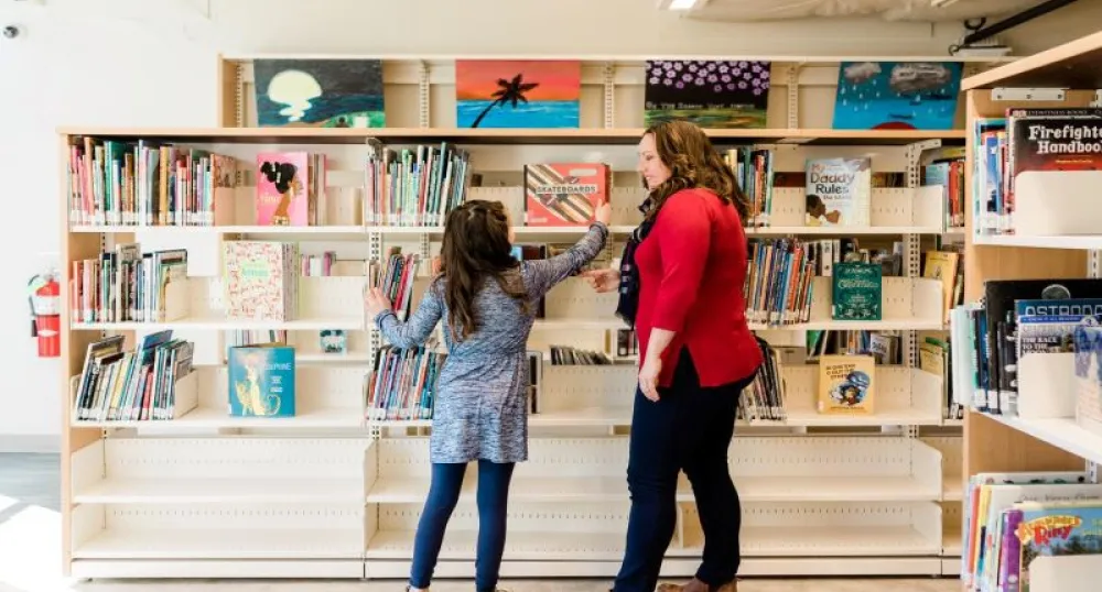 Family browsing books at library
