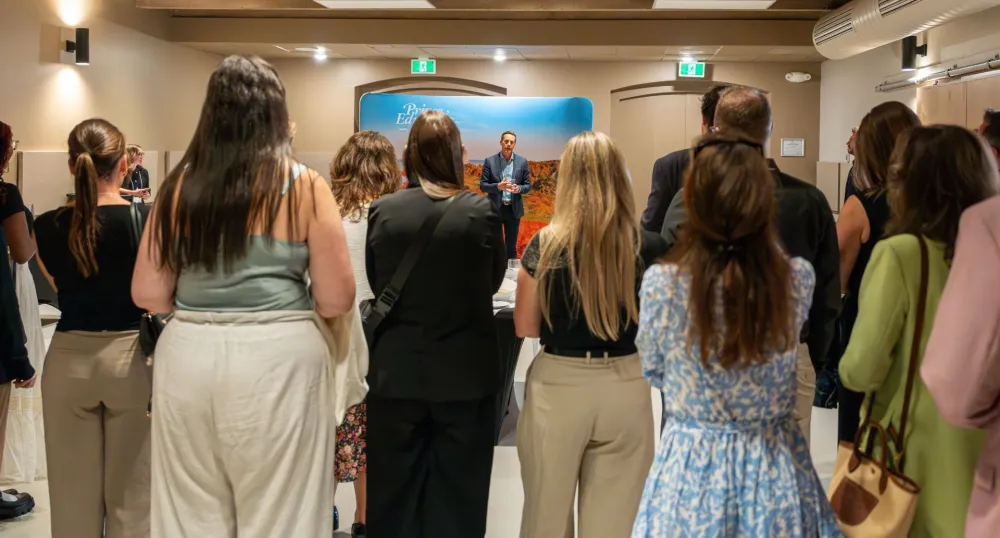 A group of med students gather around Premier Rob Lantz while he speaks.