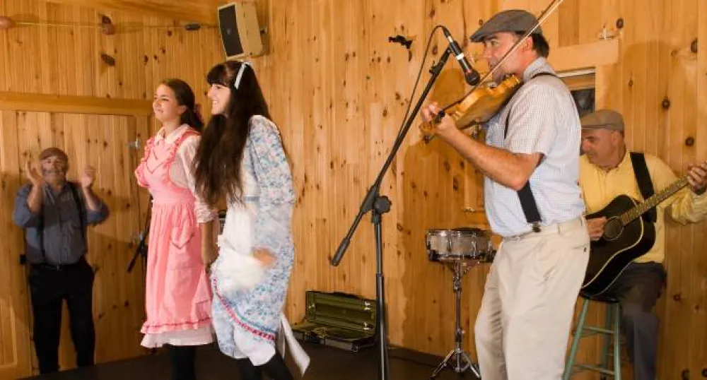 people dancing next to a fiddler