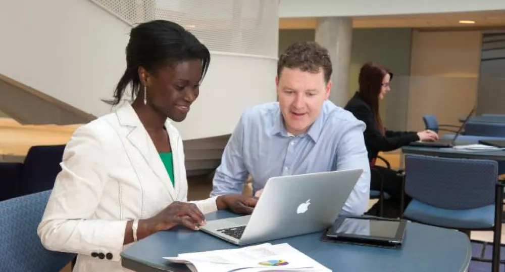 people looking at a computer