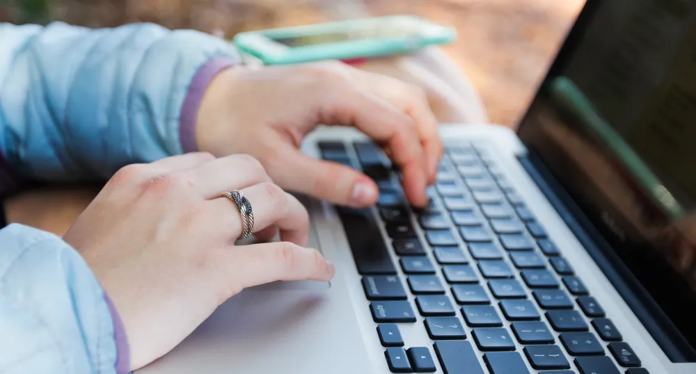 Image of person typing on a computer