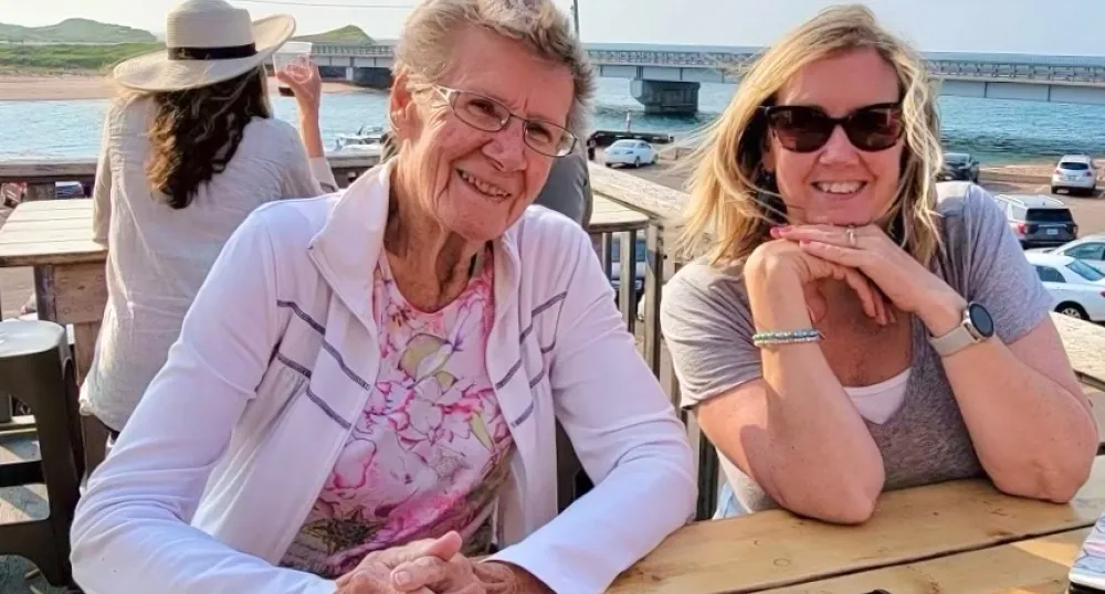 Two women, mother and daughter, smiling.