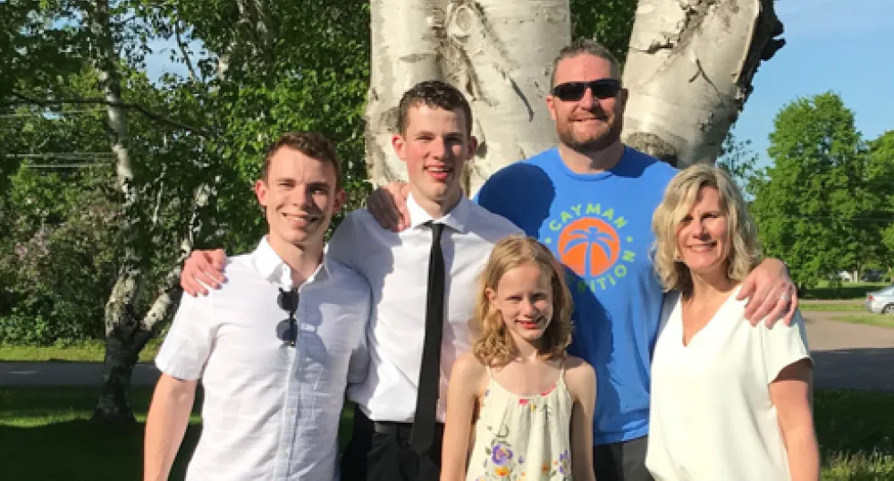 Leigh Read and his family standing by tree Leigh Read and his family standing by tree
