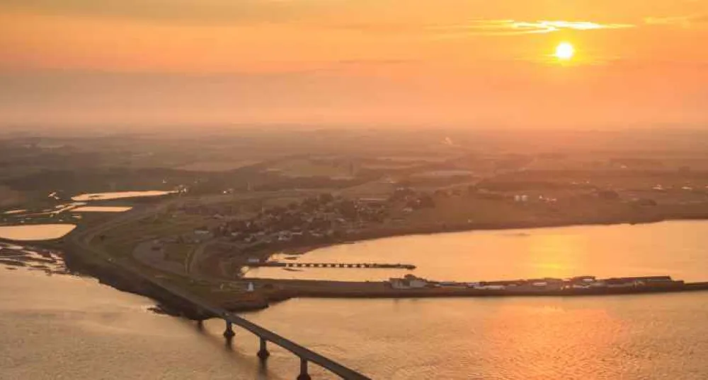 Aerial view of sun setting over Confederation Bridge looking toward Borden-Carleton