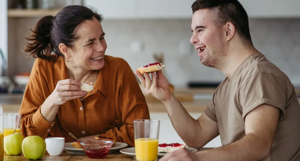 Two adults eating breakfast. 