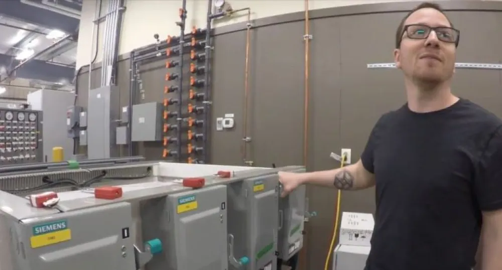 Employee monitors equipment at Aspin Kemp