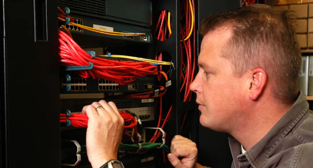 computer technician technician working on inside of computer