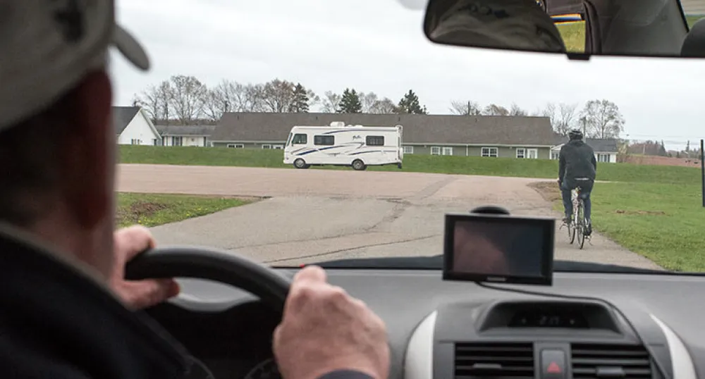 Share the Road Vehicle driver sees cyclist ahead