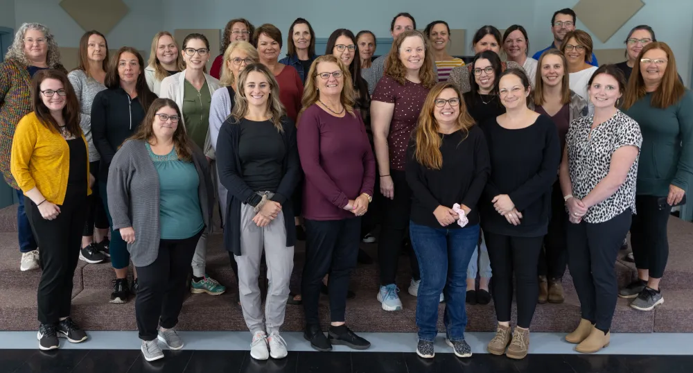The Health PEI home care team A large group photo of smiling men and women in casual clothing