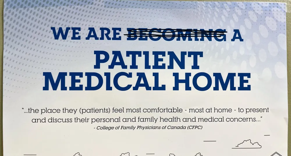 The top half of a poster which reads &quot;We are becoming a Patient Medical Home&quot; but the &quot;becoming&quot; is crossed out by a pen.