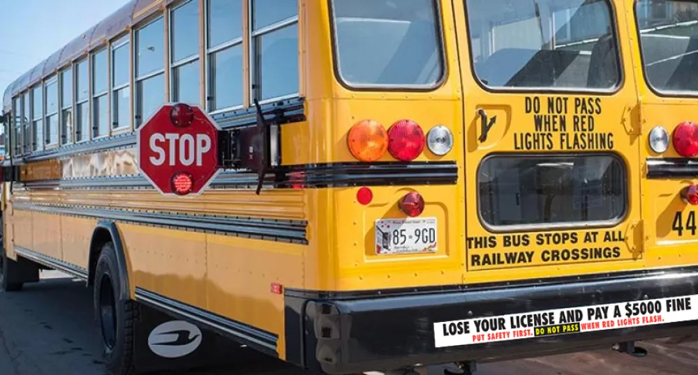 school bus with amber and red lights flashing