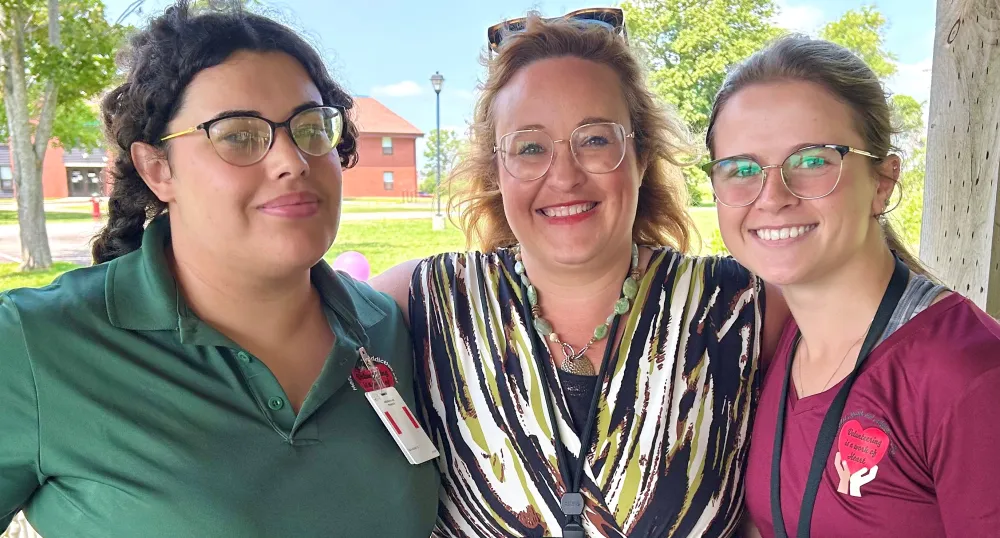 Three smiling women on a sunny day