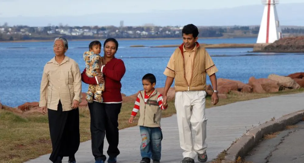 Multi-generational family walks on the boardwalk near Victoria Park