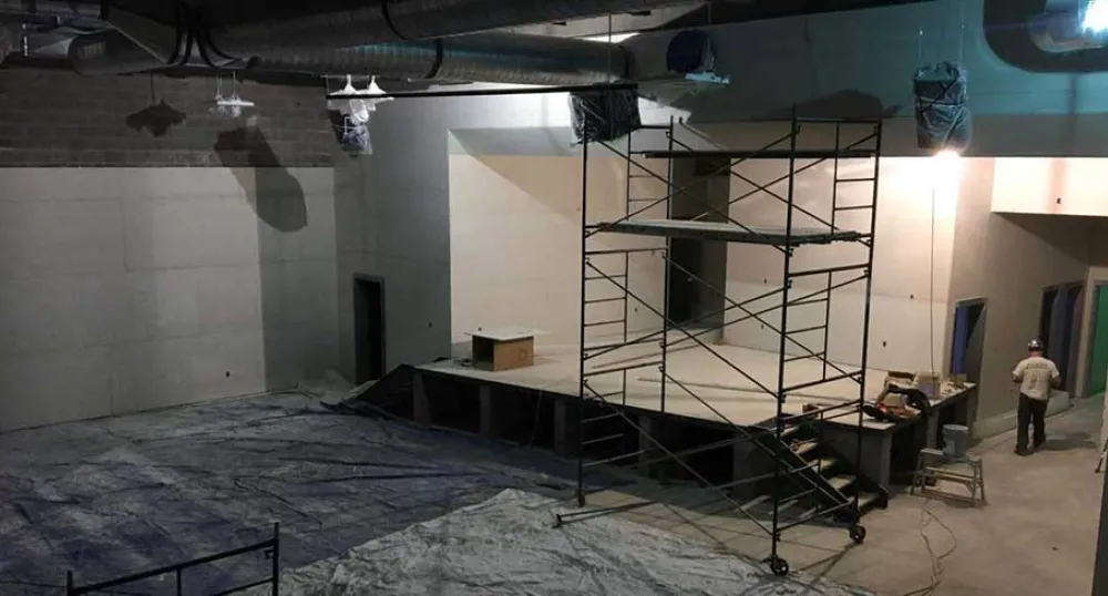 Photo shows interior construction of a large space at the new French school.