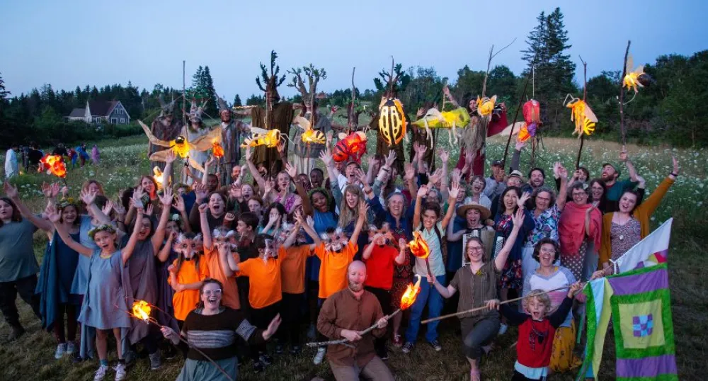 Double the amount of funding available for Anti-Racism Microgrant image of a group of people with hands held high in a field
