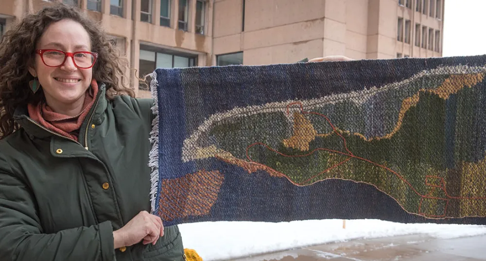 Rilla Marshall - Greenwich Peninsula, PEI Rilla Marshall displays her artwork, a handwoven and embroidered work entitled Greenwich Peninsula, PEI