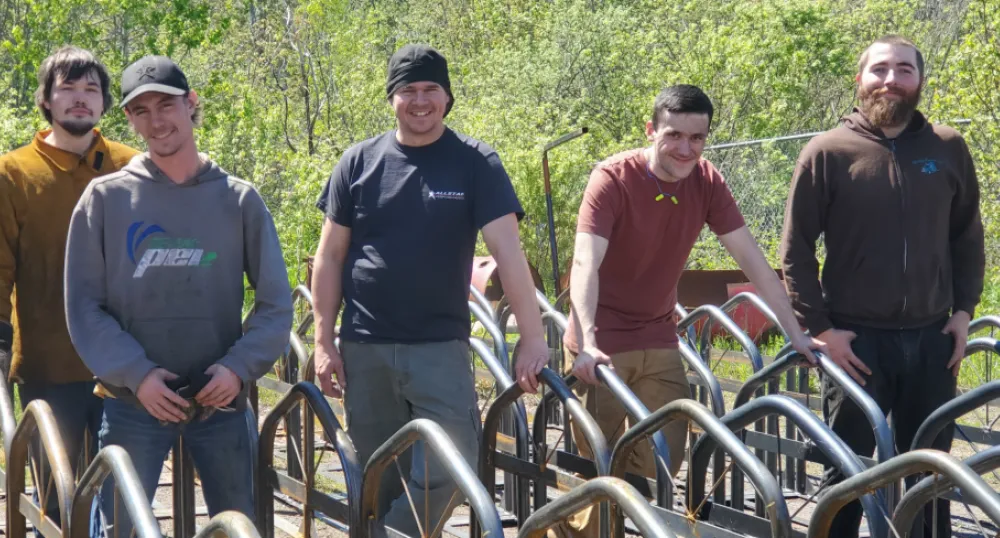 Holland College students standing behind a set of bike racks they built.