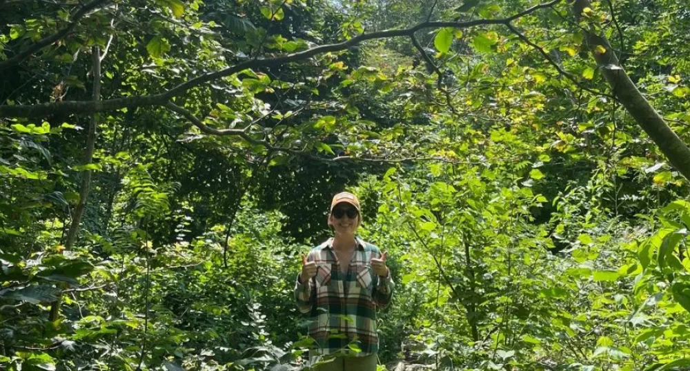 Day 3: Summer student journals learning experience in the field image of a person standing in some thick bushes and forest