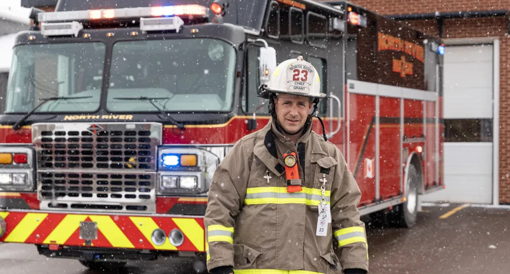 Image of Firefighter in front of firetruck