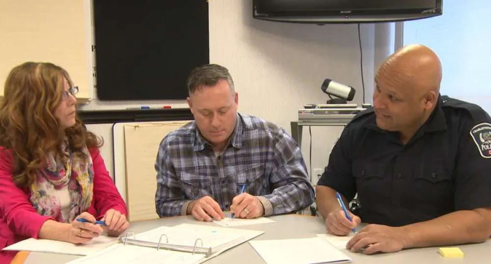 Three people sitting at a table