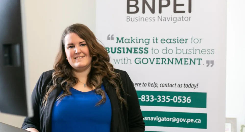 Woman standing in front of desk 