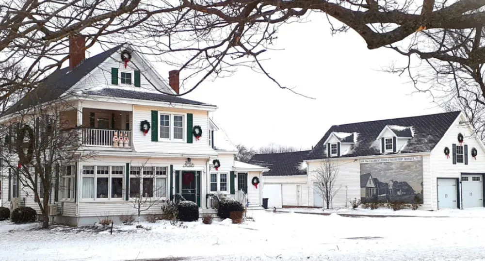 A winter photo of the Callbeck House and barn in Bedeque