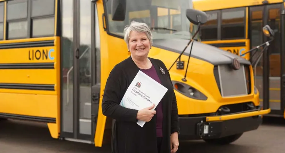 image of a person standing in front of a school bus