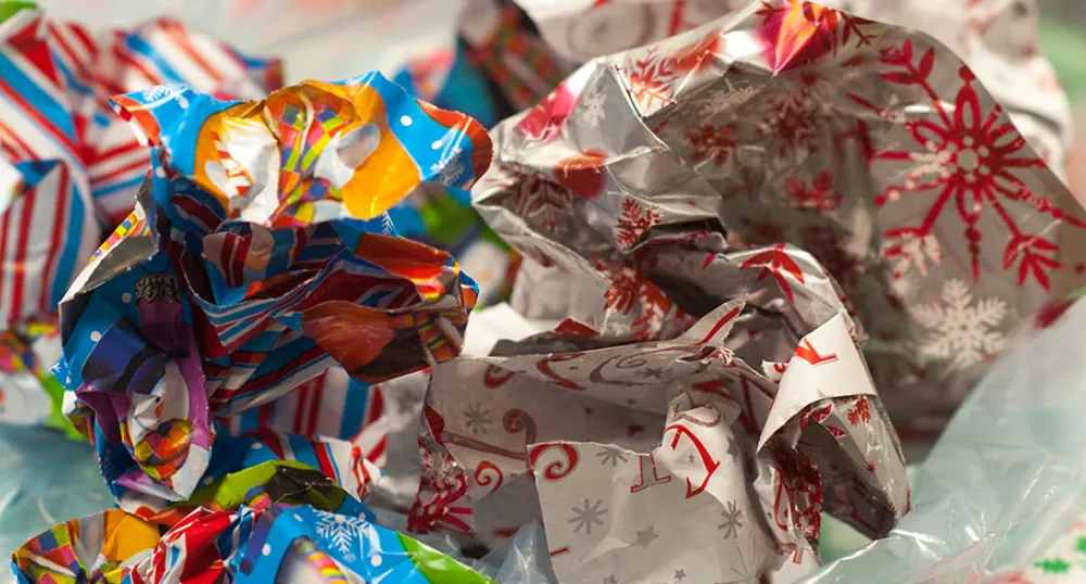 A photo colourful wrapping paper sticking out of the top of a gift bag.