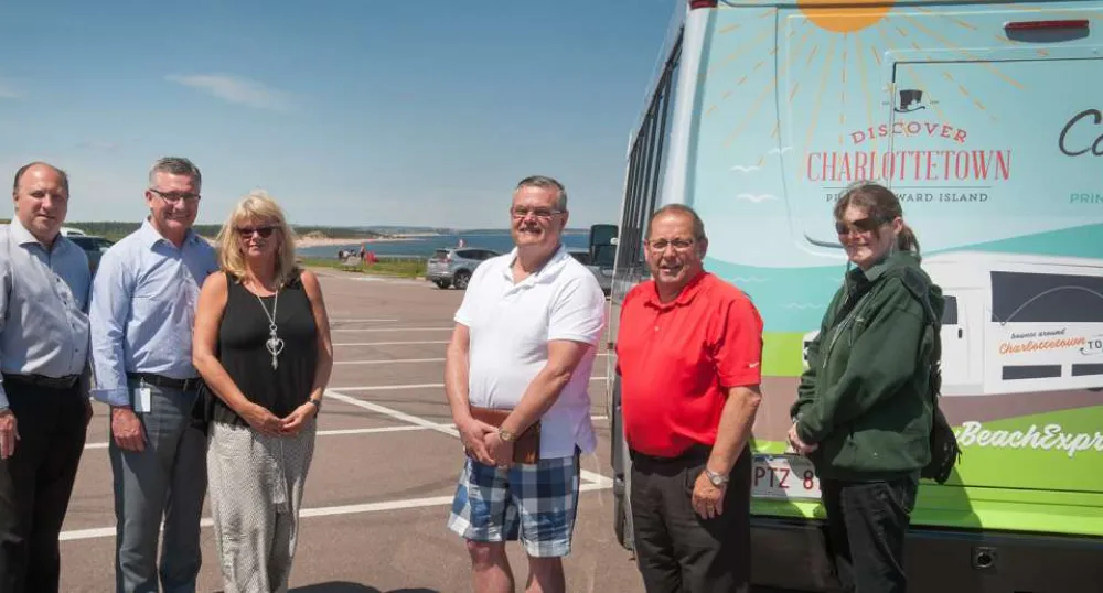 People standing in front of Cit Beach bus