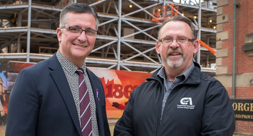 Minister Heath MacDonald stands with Sam Sanderson, general manager of the Construction Association of PEI