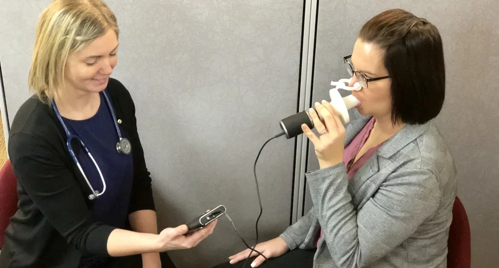 Heather Cyr administers a spirometry test.