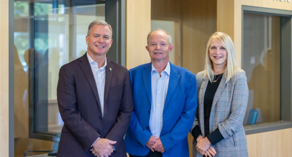 Province prepares for smooth transition of Health PEI leadership image of three people standing shoulder to shoulder in a room with a wall behind them