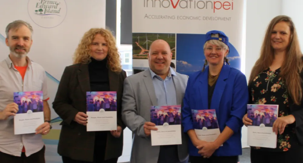 Province invests in the creative sector image of five people standing shoulder to shoulder holding colorful programs in their hands