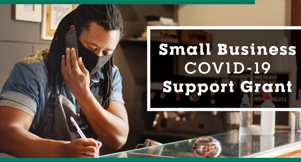 Province offers support grant for small businesses image of a person at a work counter taking an order over the phone.