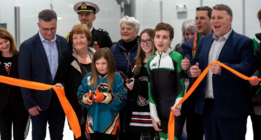 Province welcomes nation for the 2023 Canada Winter Games image of a group of people standing in a rink holding a ribbon during an opening ceremony