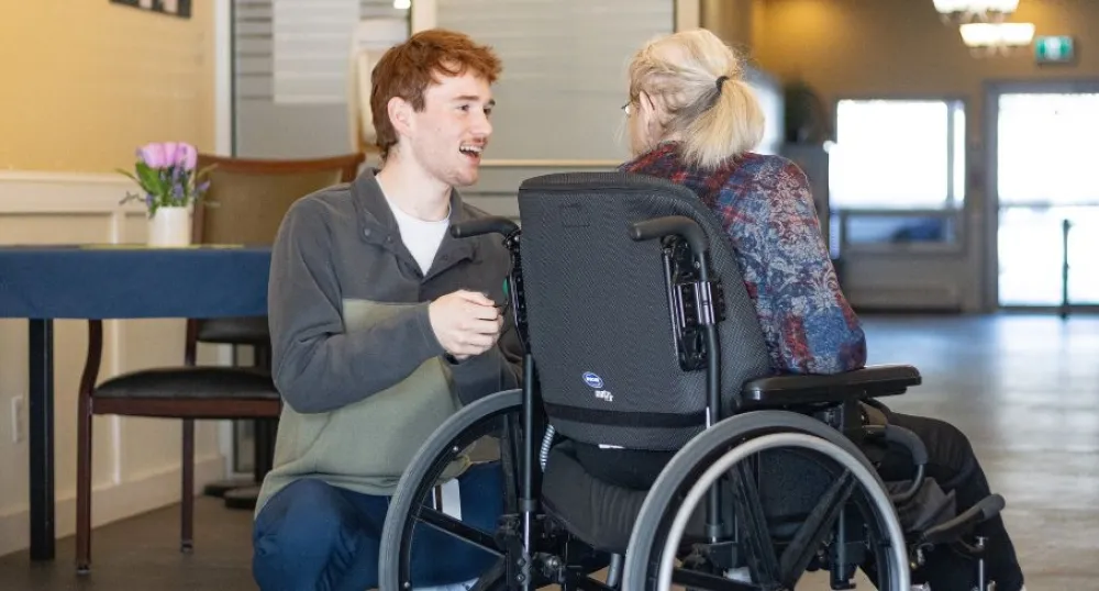 Program brings rehabilitation support to residents at Garden Home Image of youth talking to seinor in wheelchair