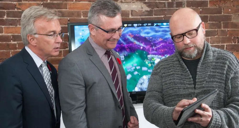 Next generation mobile games Minister MacDonald and MP Sean Casey look at tablet heald by icejam founder Stu Duncan