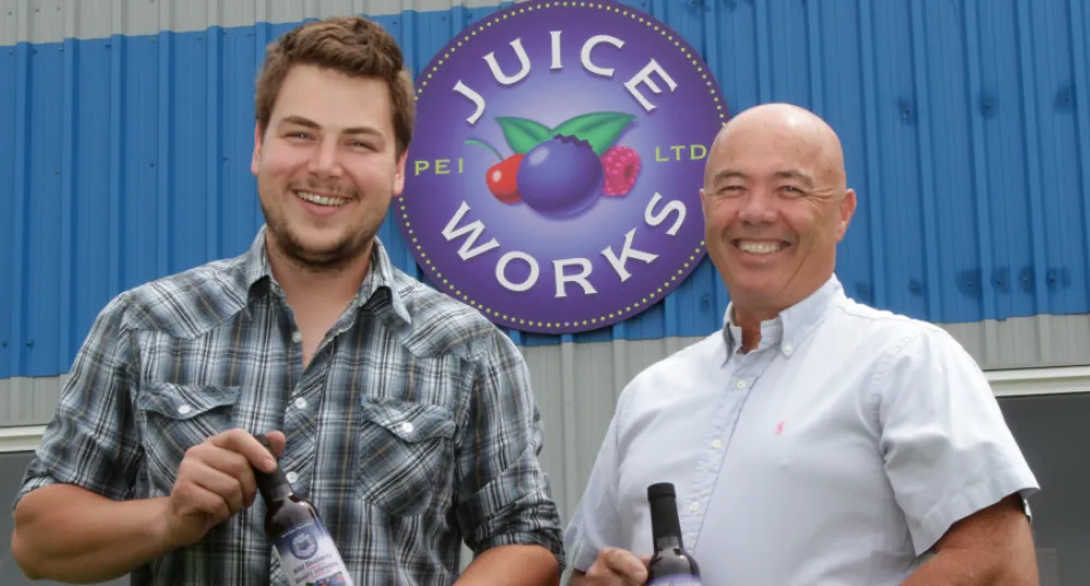 GM Jackson Platts, and President Denton Ellis proudly display their signature blueberry juice. PEI Juice Works General Manager Jackson Platts, and President Denton Ellis hold bottles of the company's signature blueberry juice.