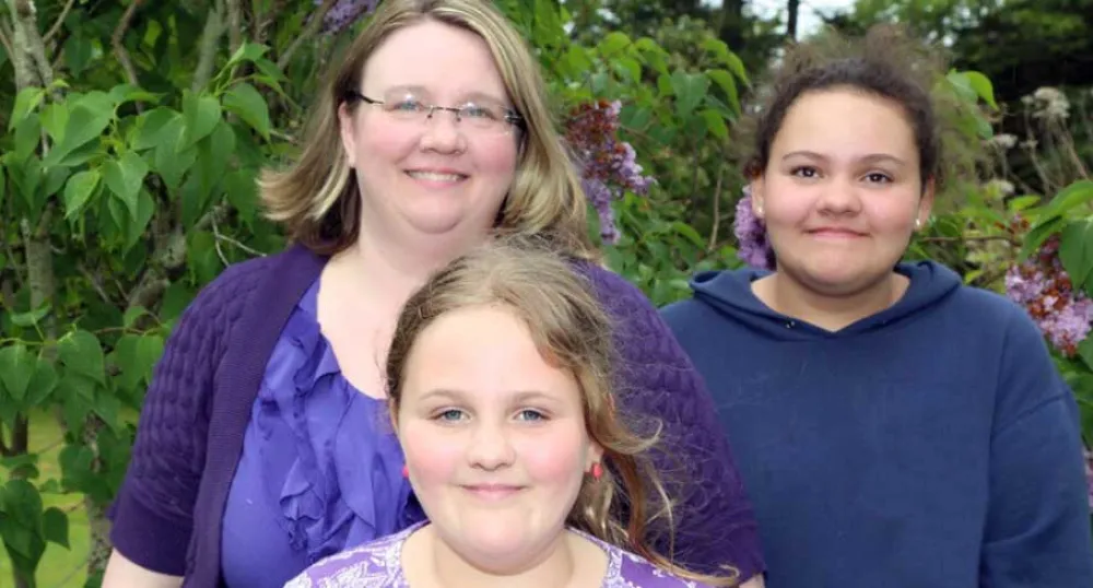 Foster parent Lori Johnston with her two daughters Lori Johnston has been a foster parent for more than 16 years