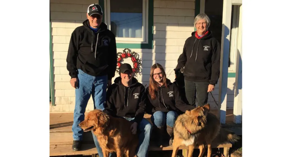 MacKinnon family and their dogs on the outside front step of their home