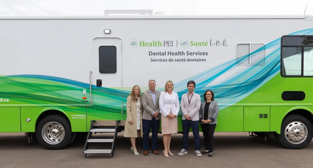 The Minister and others pictured in front of the mobile bus