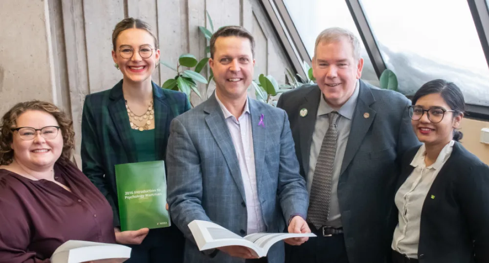 Introducing UPEI’s Open Education Resource Development program Five people standing shoulder to shoulder and three are holding books.