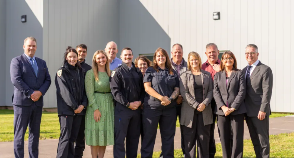 Women’s Unit at Provincial Correctional Centre near completion image of a group of people standing in front of a building