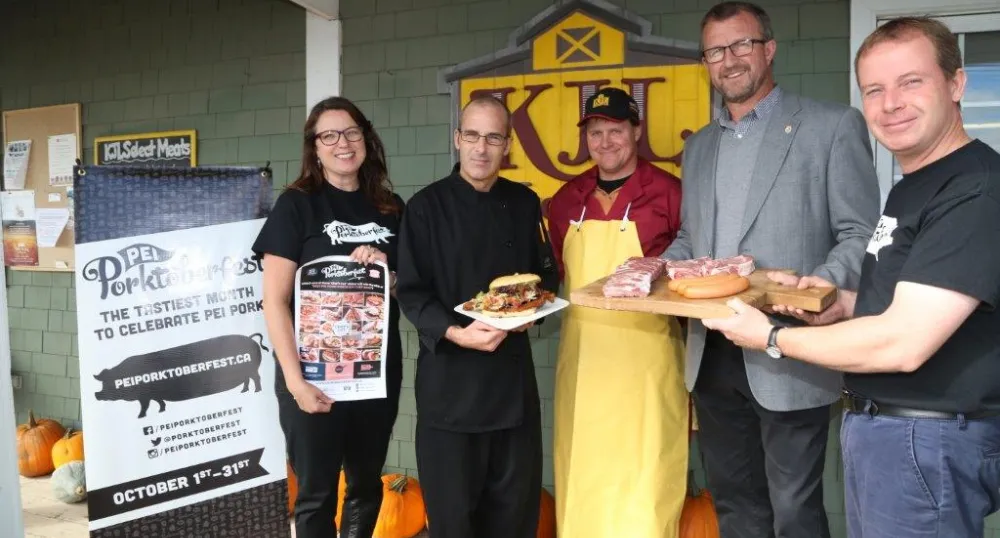 Minister Alan McIssaac and four others display Porkoberest food.