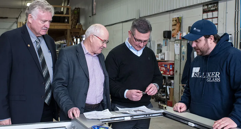 Positioning Silliker Glass for future growth in Borden-Carleton Photo shows four men examining a piece of glass