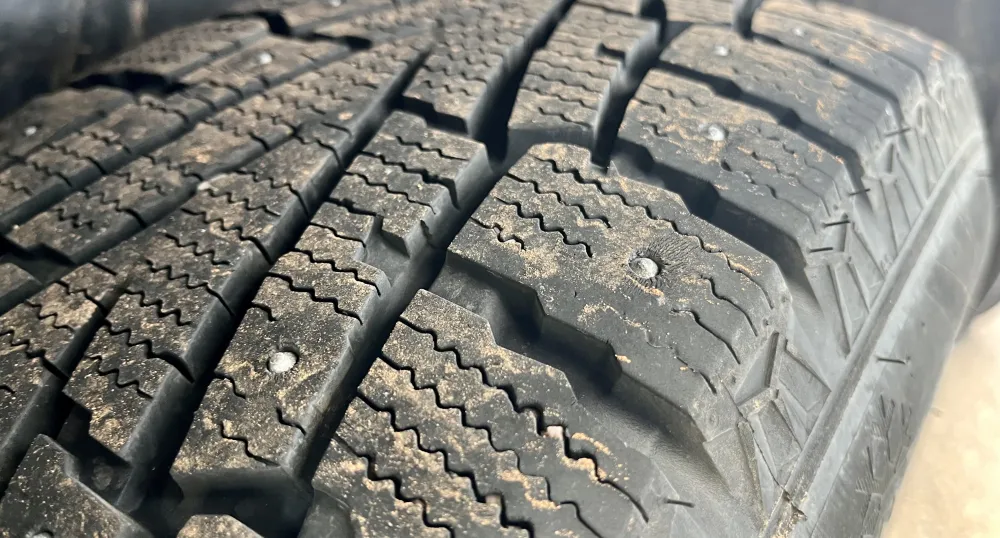 image of tire with metals studs in it