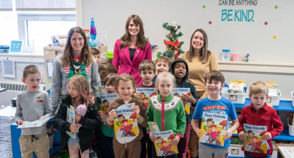 Annual program gives students in Grade 1 a free book image of school children and some adults standing together holding some books