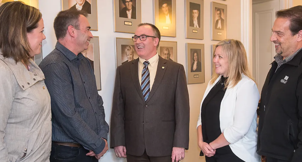 Minister Chris Palmer (centre) with TIAPEI representatives Kelly Corazza, Kirk Nicholson, Corryn Clemence, and Robert Jourdain