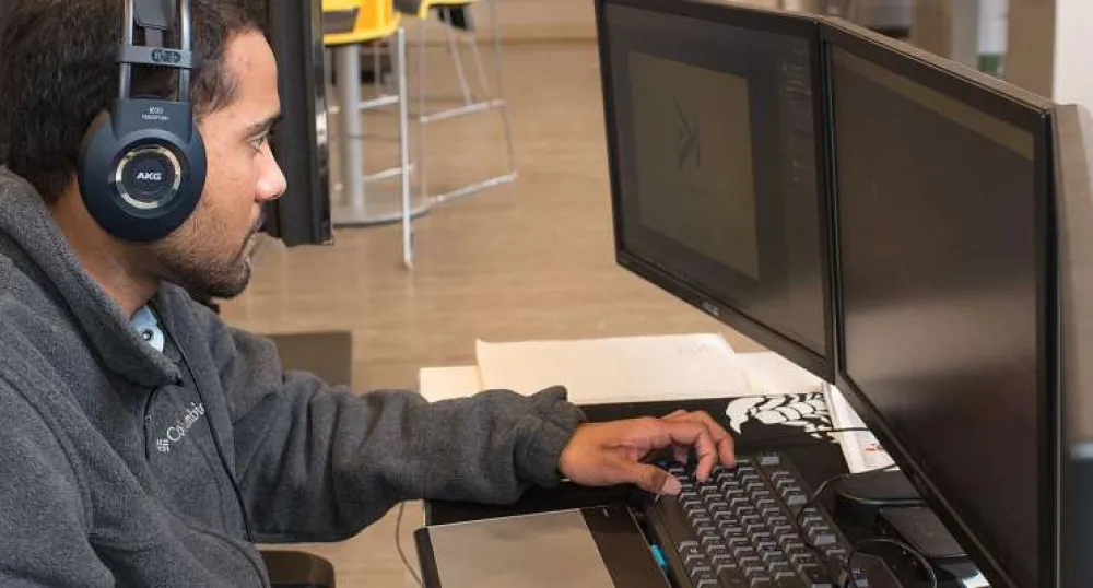 Young male works on computer