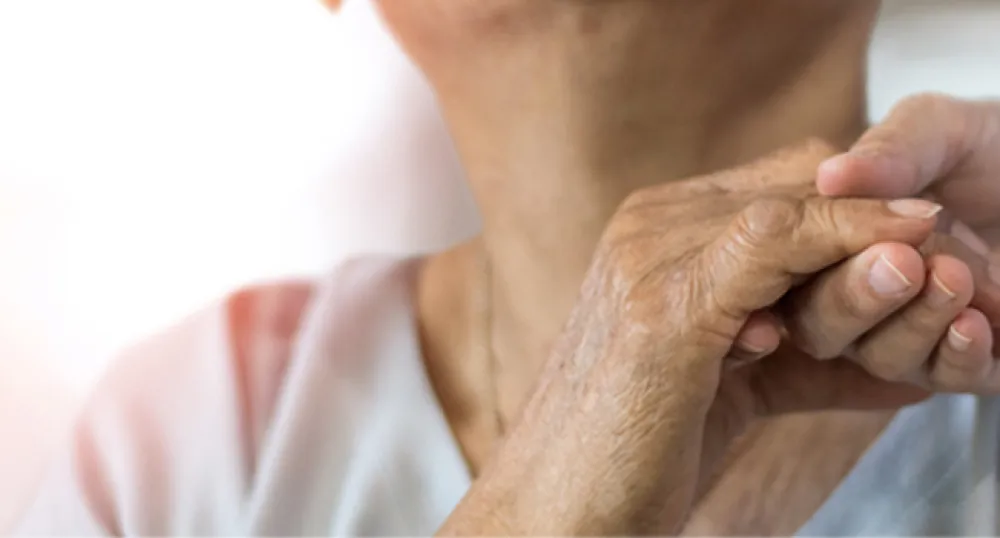 photo of an elderly woman&#039;s hand holding a younger person&#039;s hand